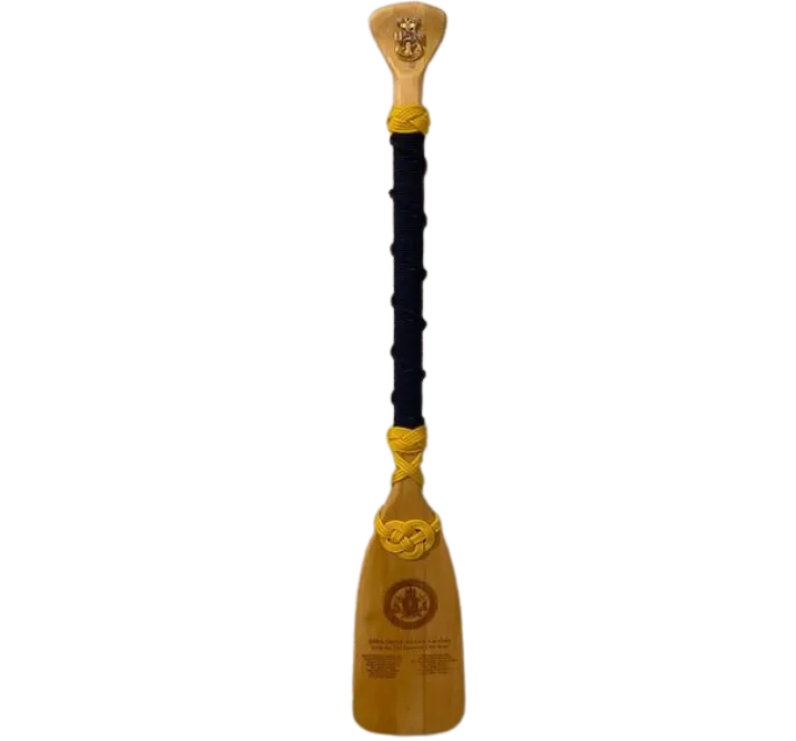 Paddle with black twining, gold knot, and a justice symbol